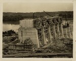 Long-Distance Shot of Wilson Dam Construction with Workers in Foreground