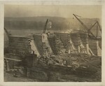Train with Construction Materials in Foreground and Construction in Background